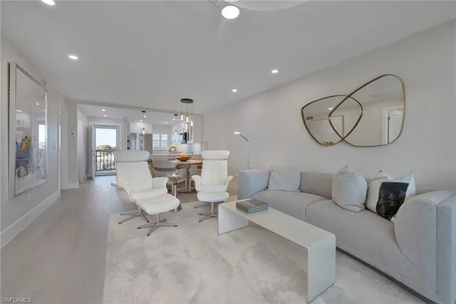 a living room with furniture and kitchen view