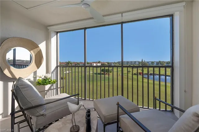 a view of a balcony with furniture and floor to ceiling window