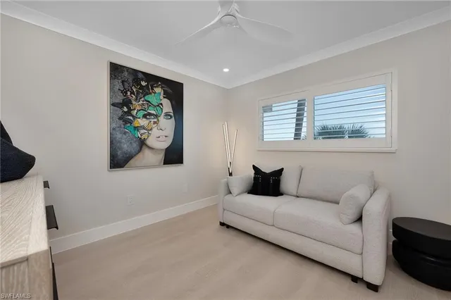 a living room with furniture and a wall painting