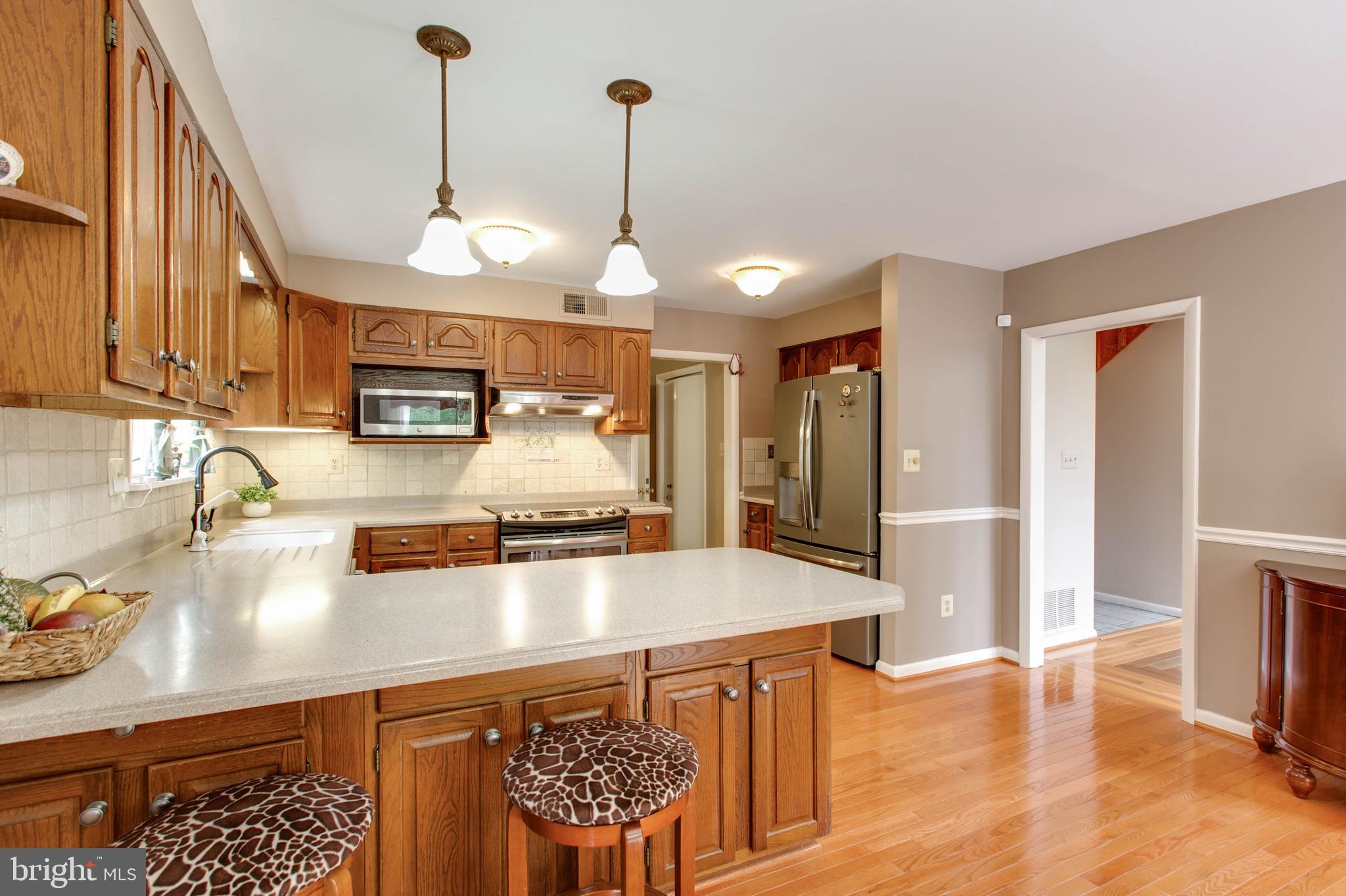 5519 Woodbine Road Sykesville, MD 21784 - Photo 19 of 69 a kitchen with stainless steel appliances granite countertop a sink a stove and a wooden floors