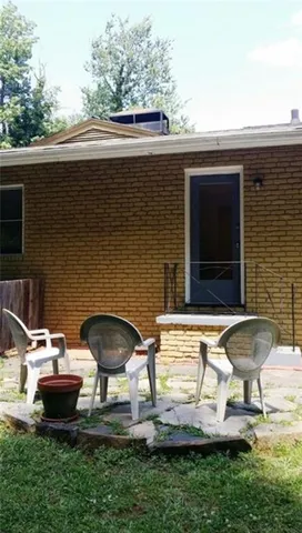 a backyard of a house with yard and outdoor seating