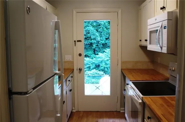 a view of an entryway with wooden floor