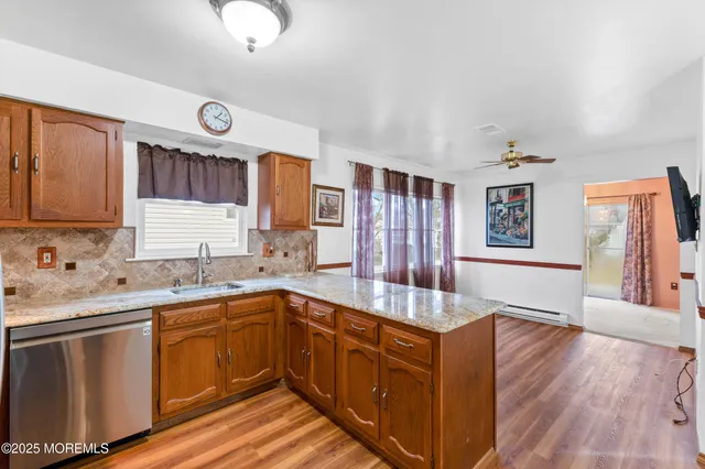 a kitchen with granite countertop a sink a stove and cabinets