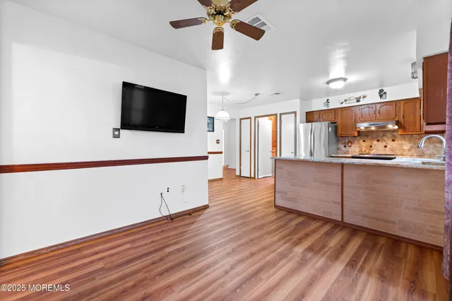 a view of a big room with windows and an empty room