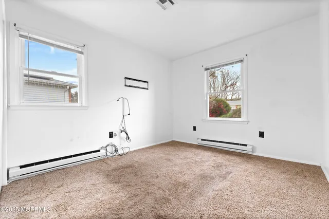 a bathroom with a sink toilet and window