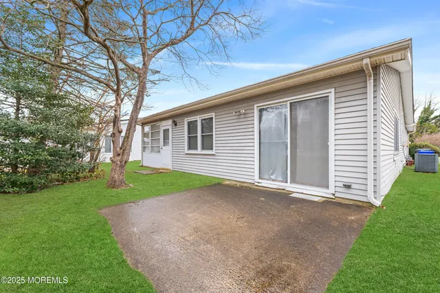 a view of house with a yard