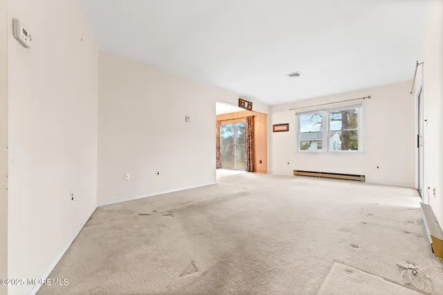 en empty room with windows and closet