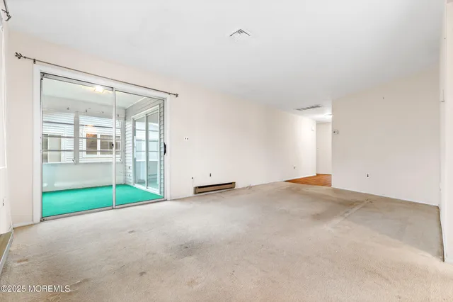 a view of empty room with floor to ceiling window