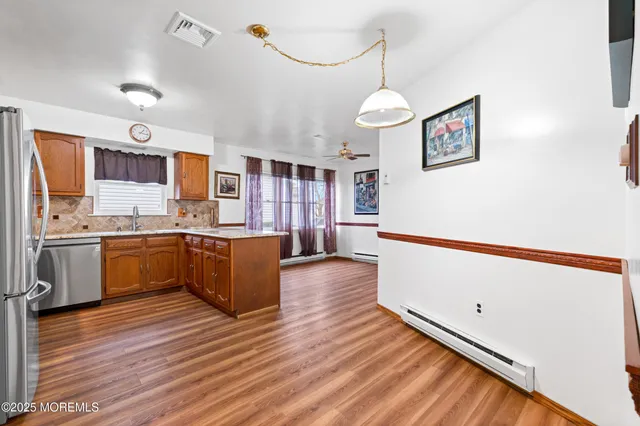a kitchen with stainless steel appliances granite countertop a refrigerator and a stove top oven