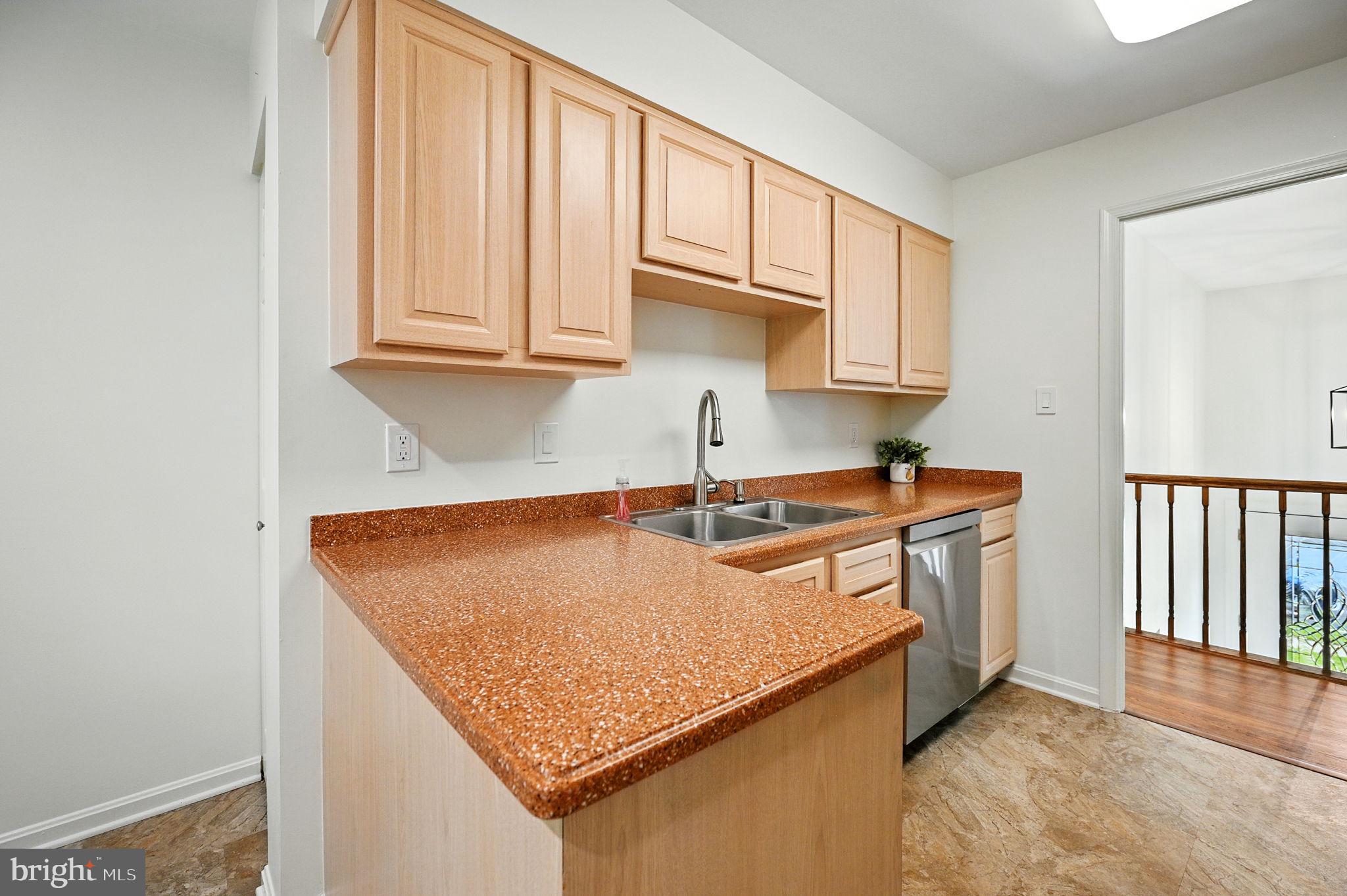 8923 Renshaw Court Springfield, VA 22153 - Photo 20 of 38 a kitchen with stainless steel appliances granite countertop a sink stove and cabinets