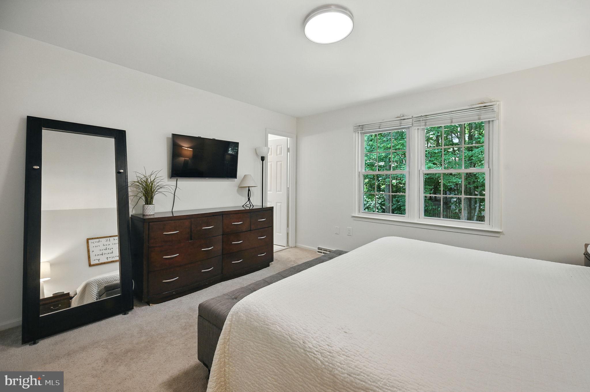 8923 Renshaw Court Springfield, VA 22153 - Photo 26 of 38 a bedroom with a bed and a flat screen tv