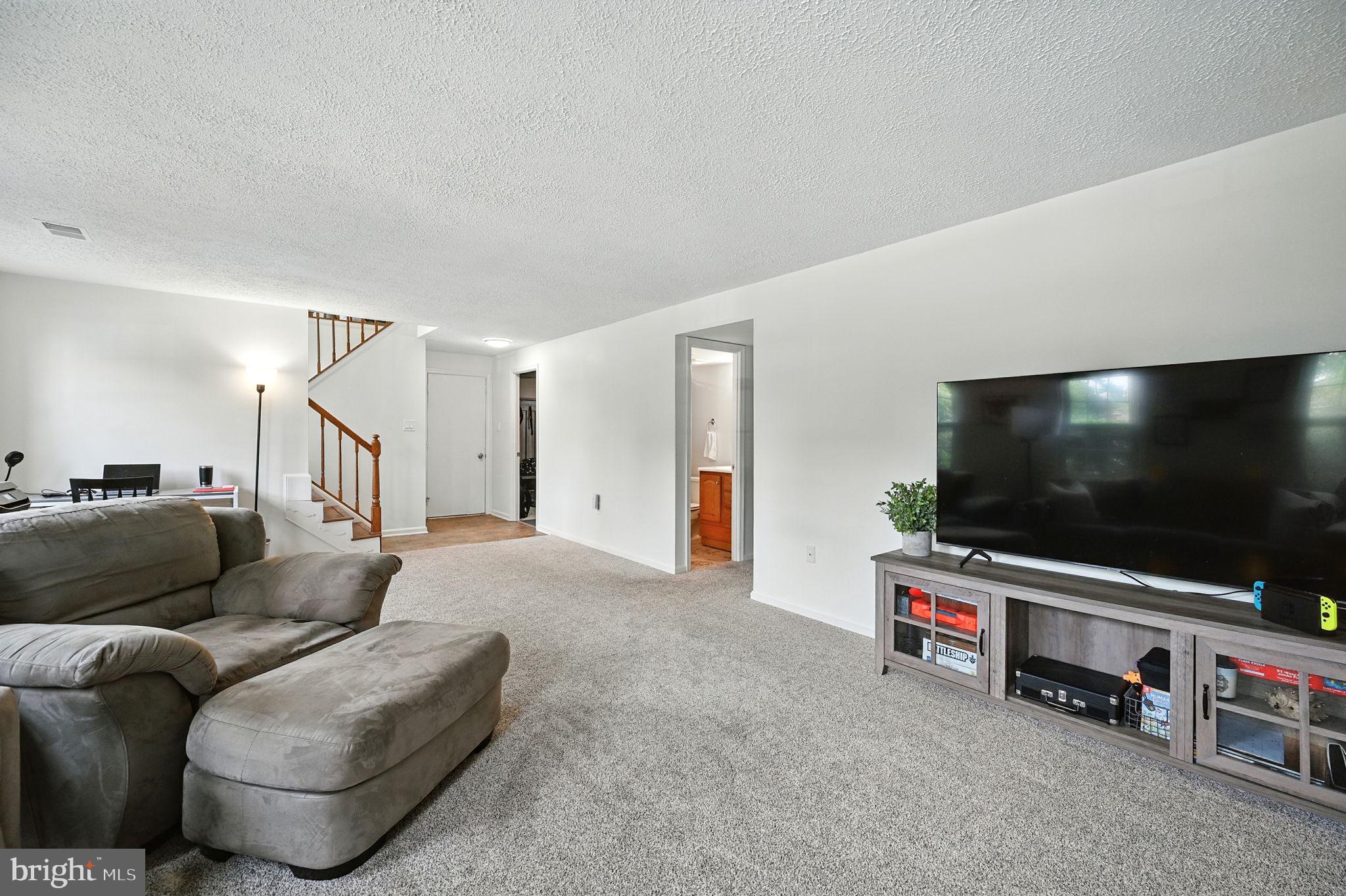 8923 Renshaw Court Springfield, VA 22153 - Photo 4 of 38 a living room with furniture and a flat screen tv
