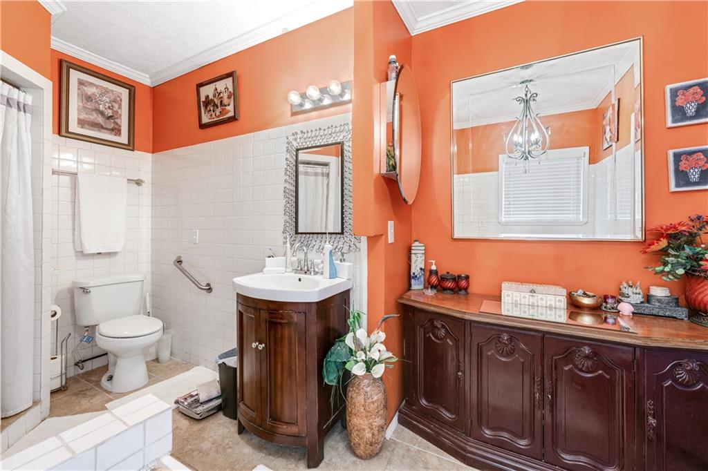 3960 Highway 20 Conyers, GA 30013 - Photo 20 of 57 a bathroom with a sink a toilet and mirror