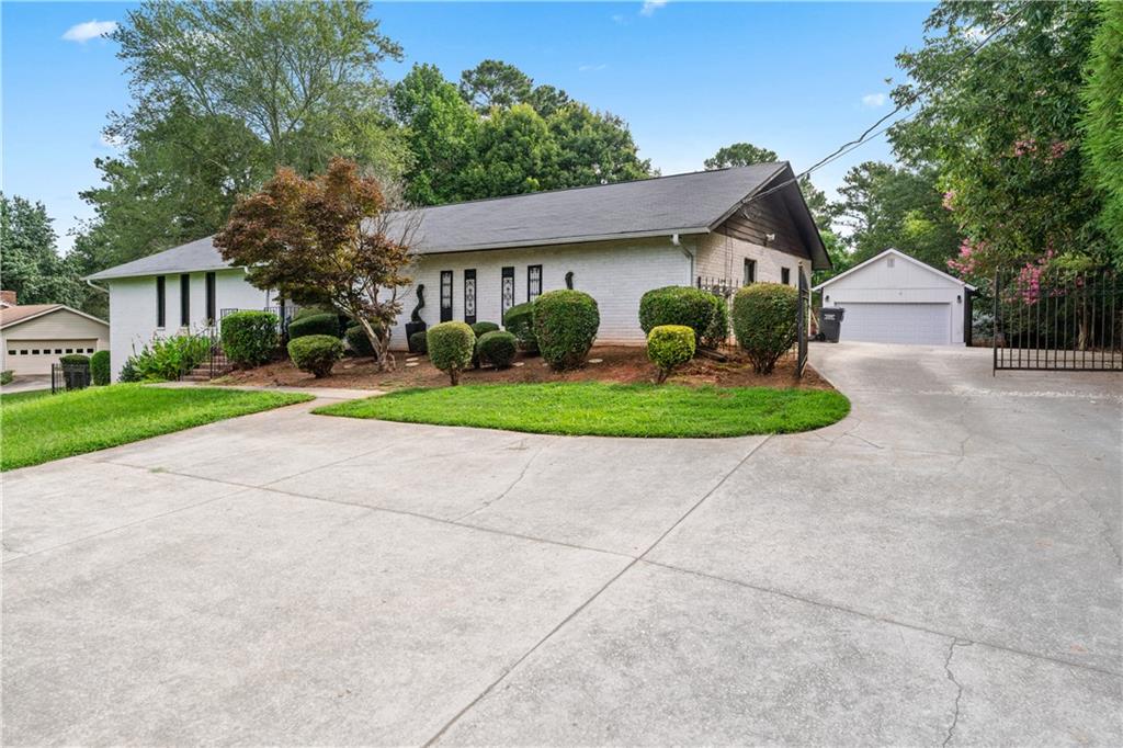3960 Highway 20 Conyers, GA 30013 - Photo 2 of 57 a front view of a house with a yard and garage