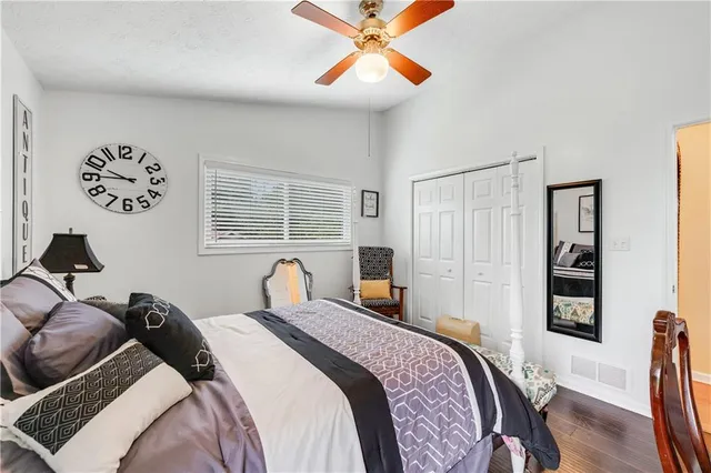a bedroom with a bed a dresser and a window