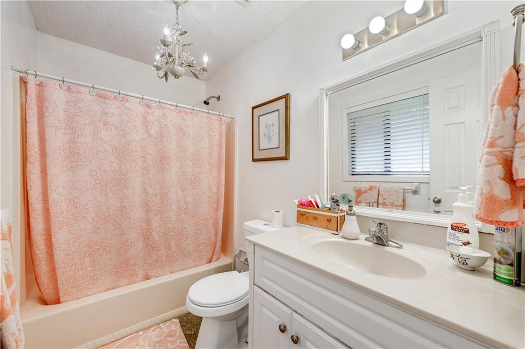 3960 Highway 20 Conyers, GA 30013 - Photo 28 of 57 a bathroom with a sink toilet mirror and vanity