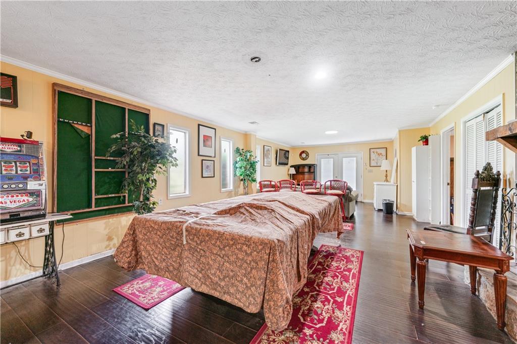 3960 Highway 20 Conyers, GA 30013 - Photo 34 of 57 a spacious bedroom with a bed and large windows