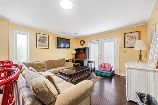 a room with painting on the wall and a window