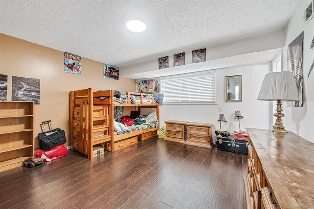 a view of a patio with table and chairs under an umbrella