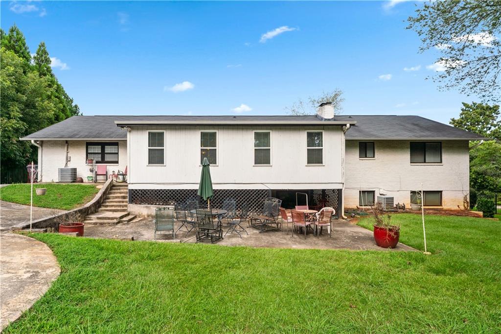 3960 Highway 20 Conyers, GA 30013 - Photo 43 of 57 a view of a patio with table and chairs under an umbrella