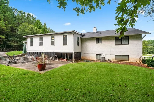 a pathway of a house with a yard and garden