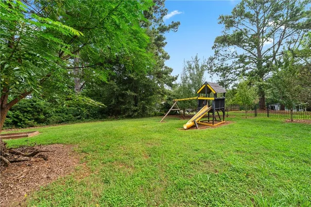 an aerial view of a house with garden space and sitting area