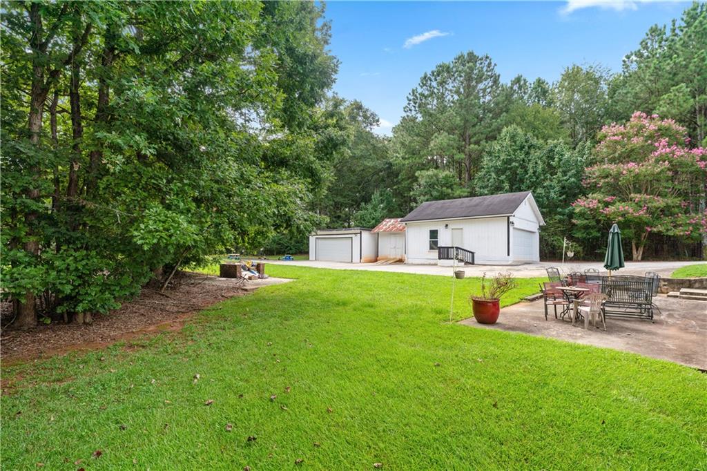 3960 Highway 20 Conyers, GA 30013 - Photo 46 of 57 a house view with a sitting space and garden