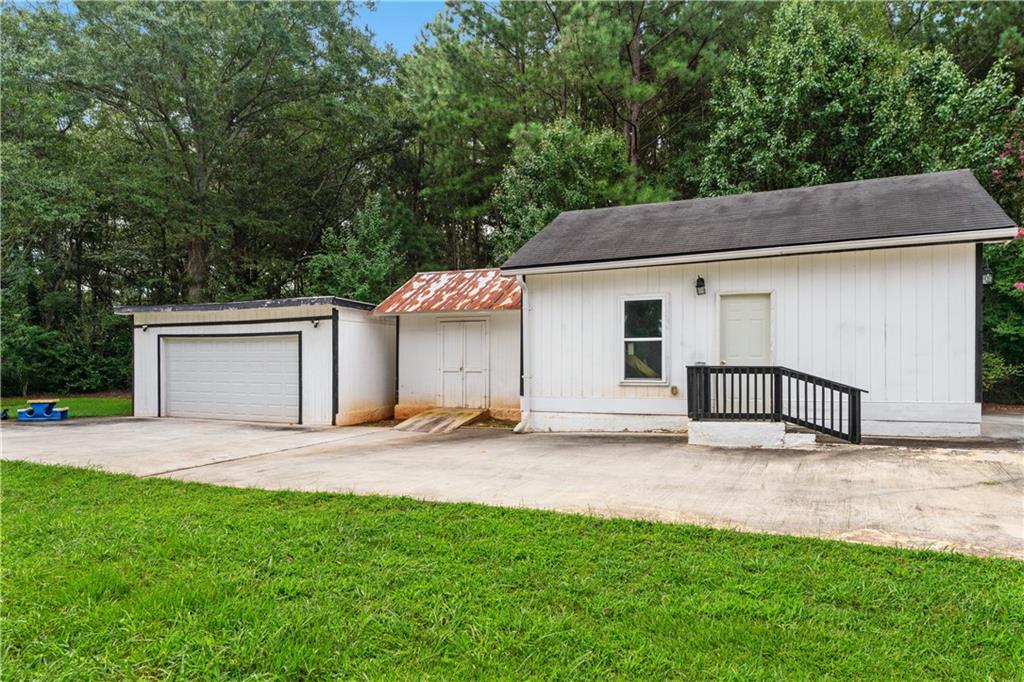 3960 Highway 20 Conyers, GA 30013 - Photo 47 of 57 a white house that has a tree in front of it