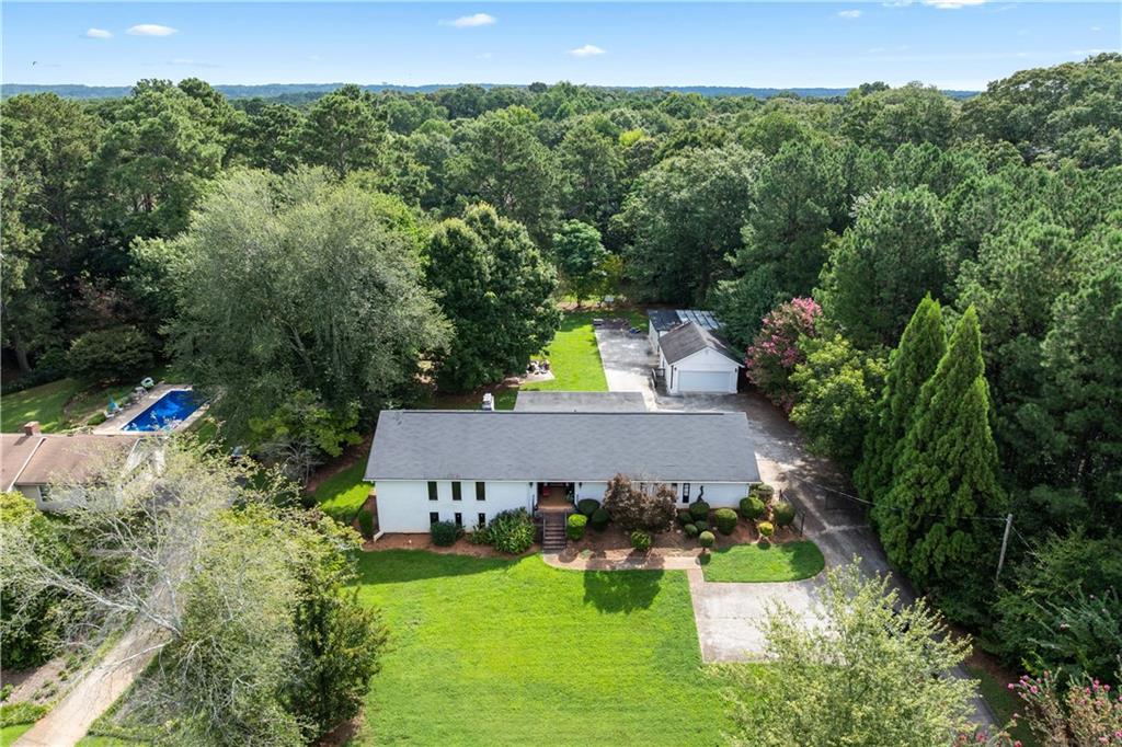 3960 Highway 20 Conyers, GA 30013 - Photo 55 of 57 an aerial view of a house with yard and trees in the background