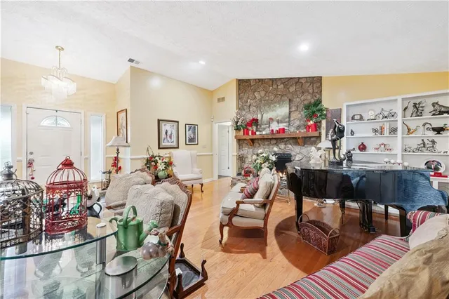 a living room with lots of furniture and a painting on the wall
