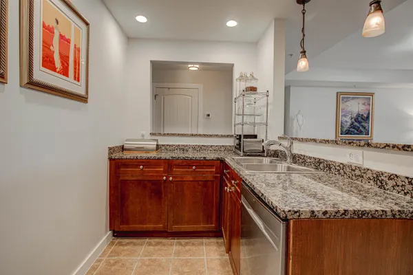 a kitchen with stainless steel appliances granite countertop a sink stove and cabinets