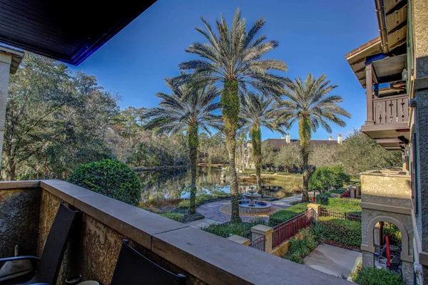 a view of a palm trees front of the house