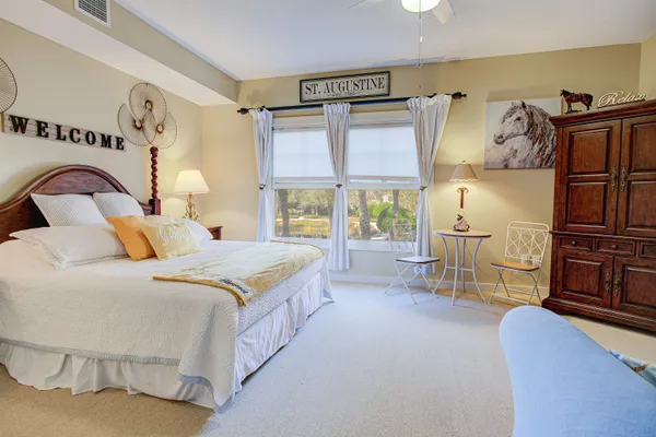 a bedroom with a bed and large window