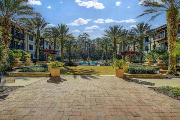 a building exterior with palm trees