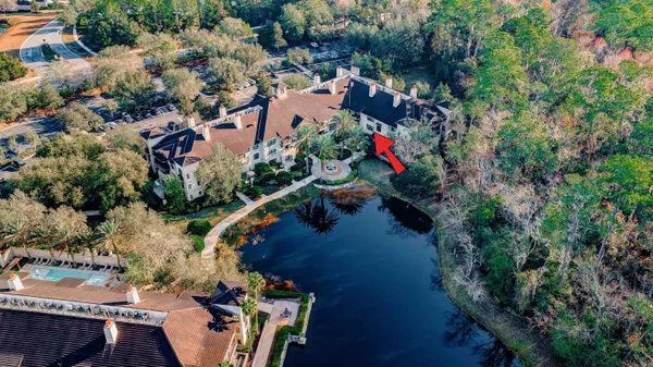 an aerial view of residential houses with outdoor space and trees