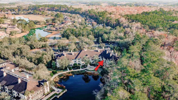 an aerial view of a house with a yard