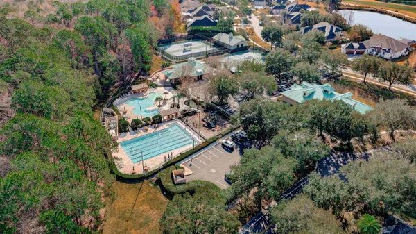 an aerial view of a house with a swimming pool and outdoor space