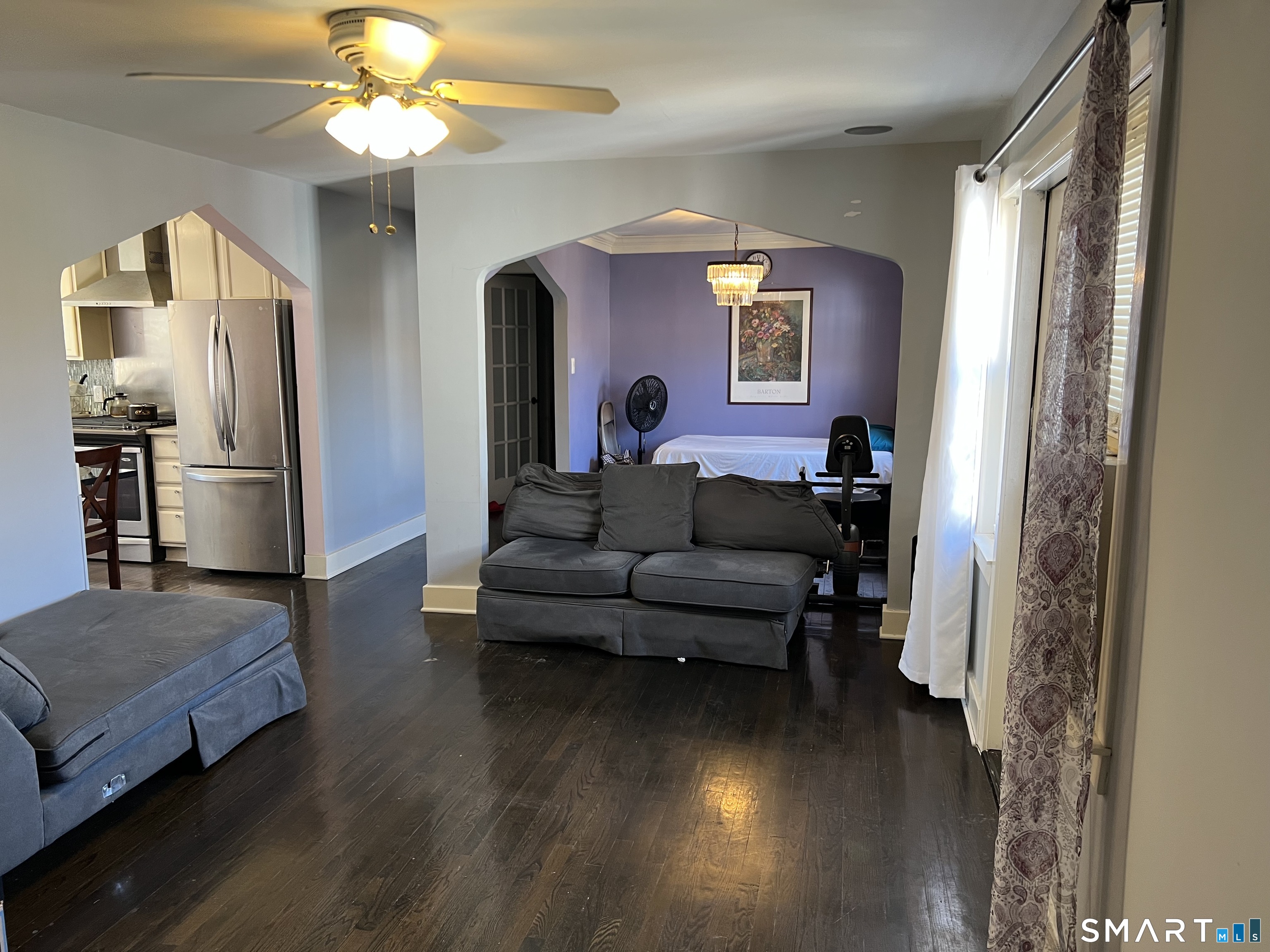 37 Canaan Court, Unit 22 Stratford, CT 06614 - Photo 2 of 16 a living room with furniture and a chandelier
