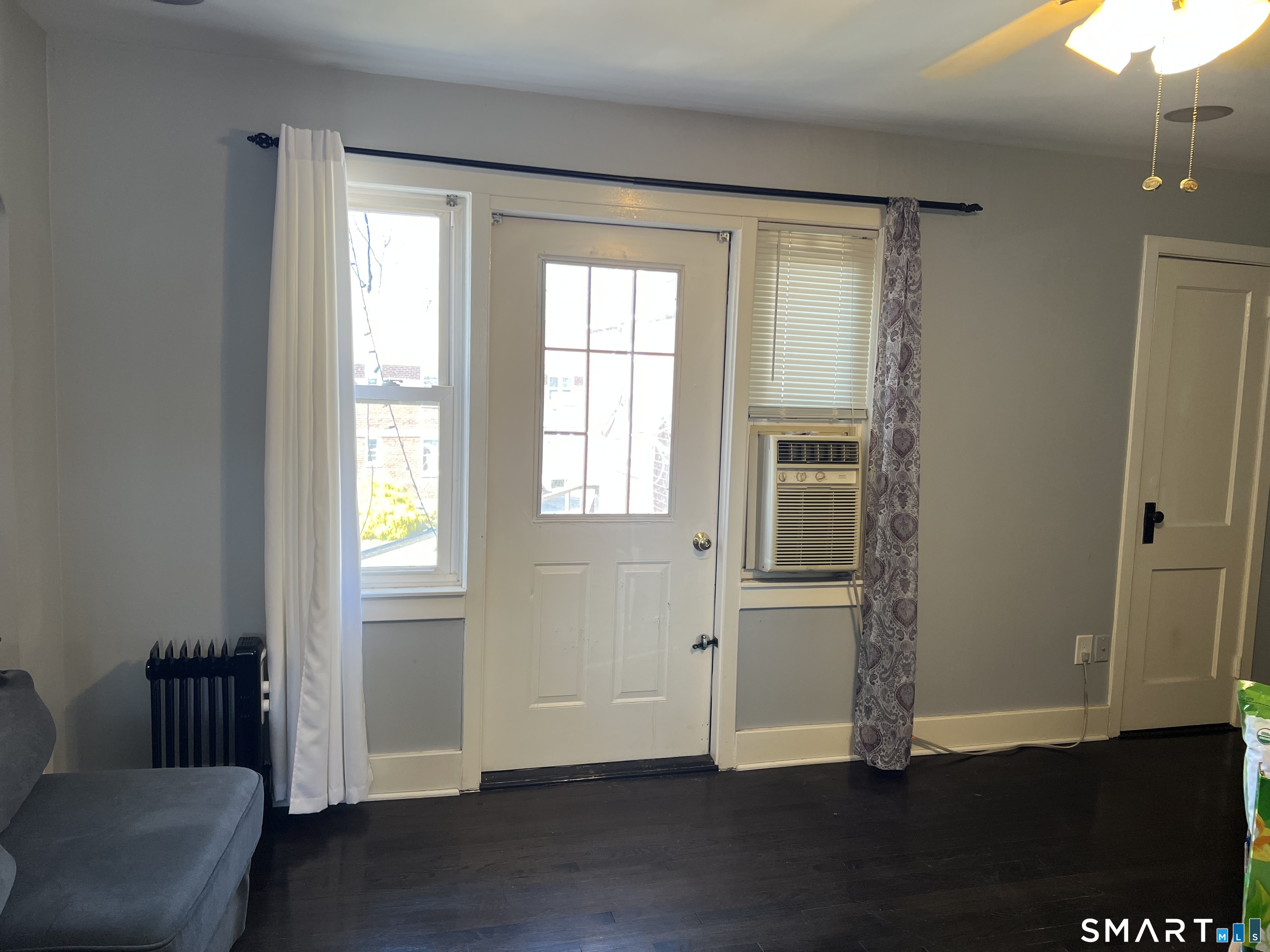 37 Canaan Court, Unit 22 Stratford, CT 06614 - Photo 5 of 16 a view of empty room with wooden floor and fan