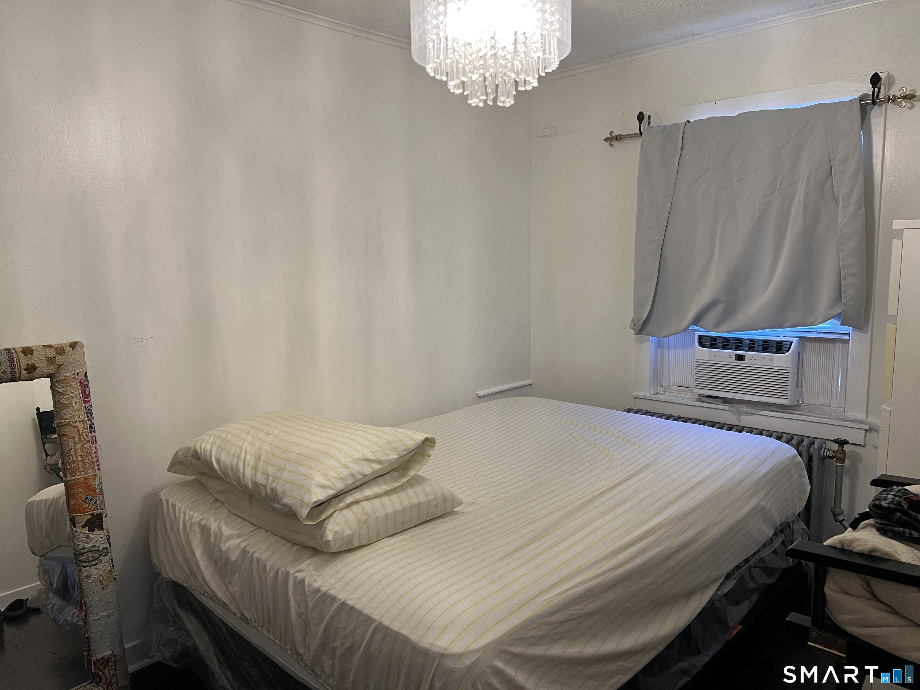 37 Canaan Court, Unit 22 Stratford, CT 06614 - Photo 10 of 16 a bedroom with a bed and a mirror