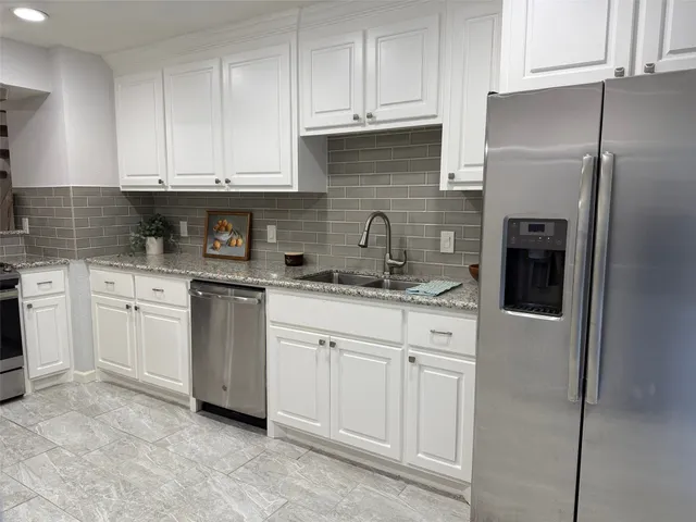 a kitchen with stainless steel appliances granite countertop a refrigerator sink and cabinets