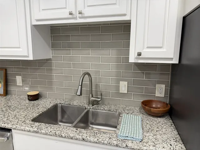 a kitchen with a sink and a stove