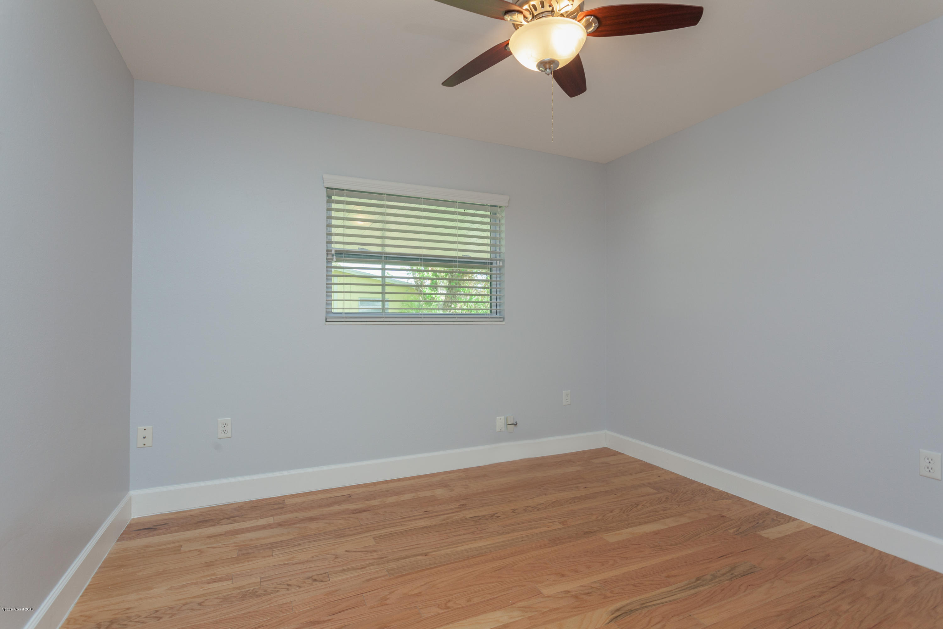 731 Java Road Cocoa Beach, FL 32931 - Photo 11 of 18 a view of an empty room with wooden floor and a window