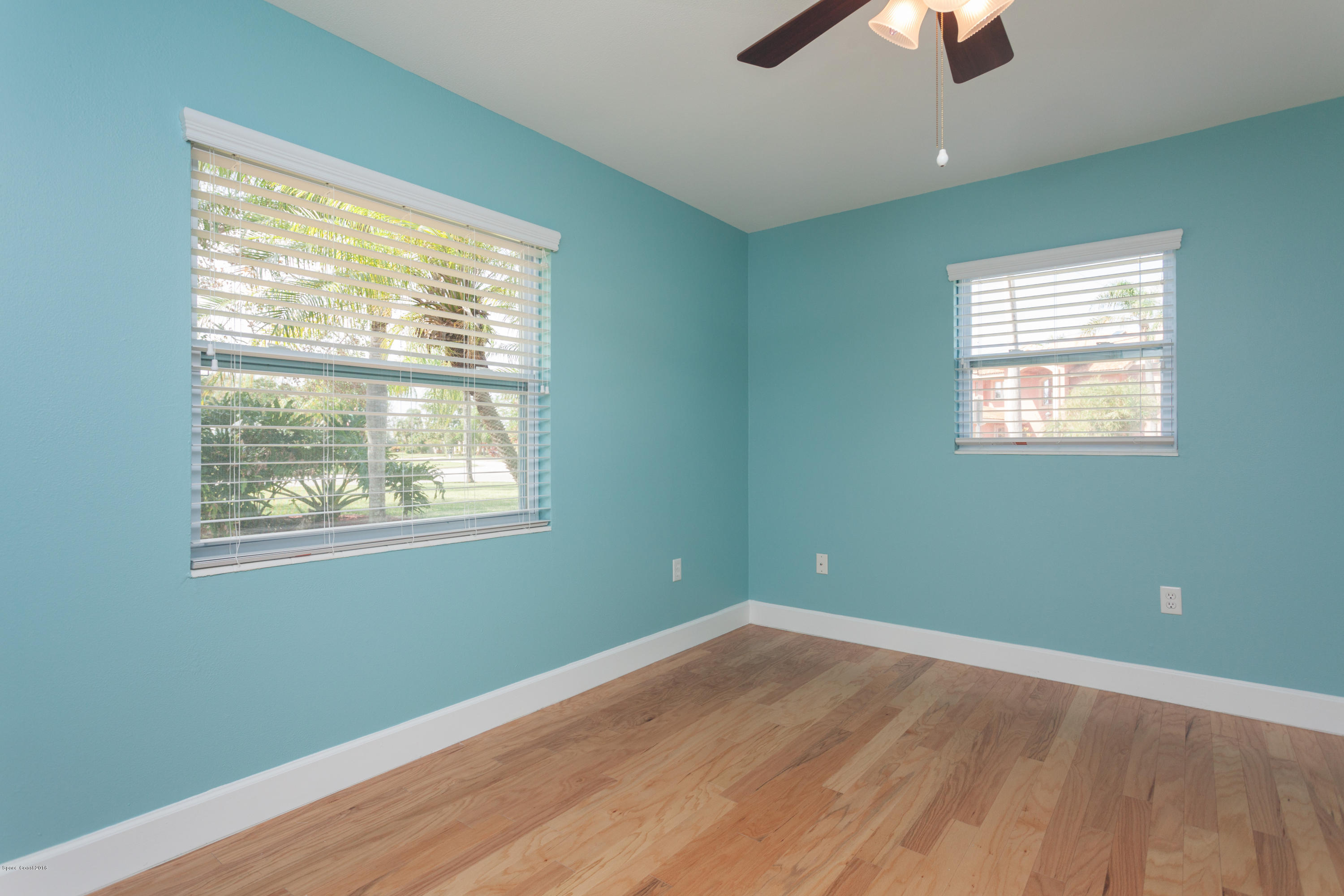 731 Java Road Cocoa Beach, FL 32931 - Photo 12 of 18 a view of empty room with wooden floor and fan