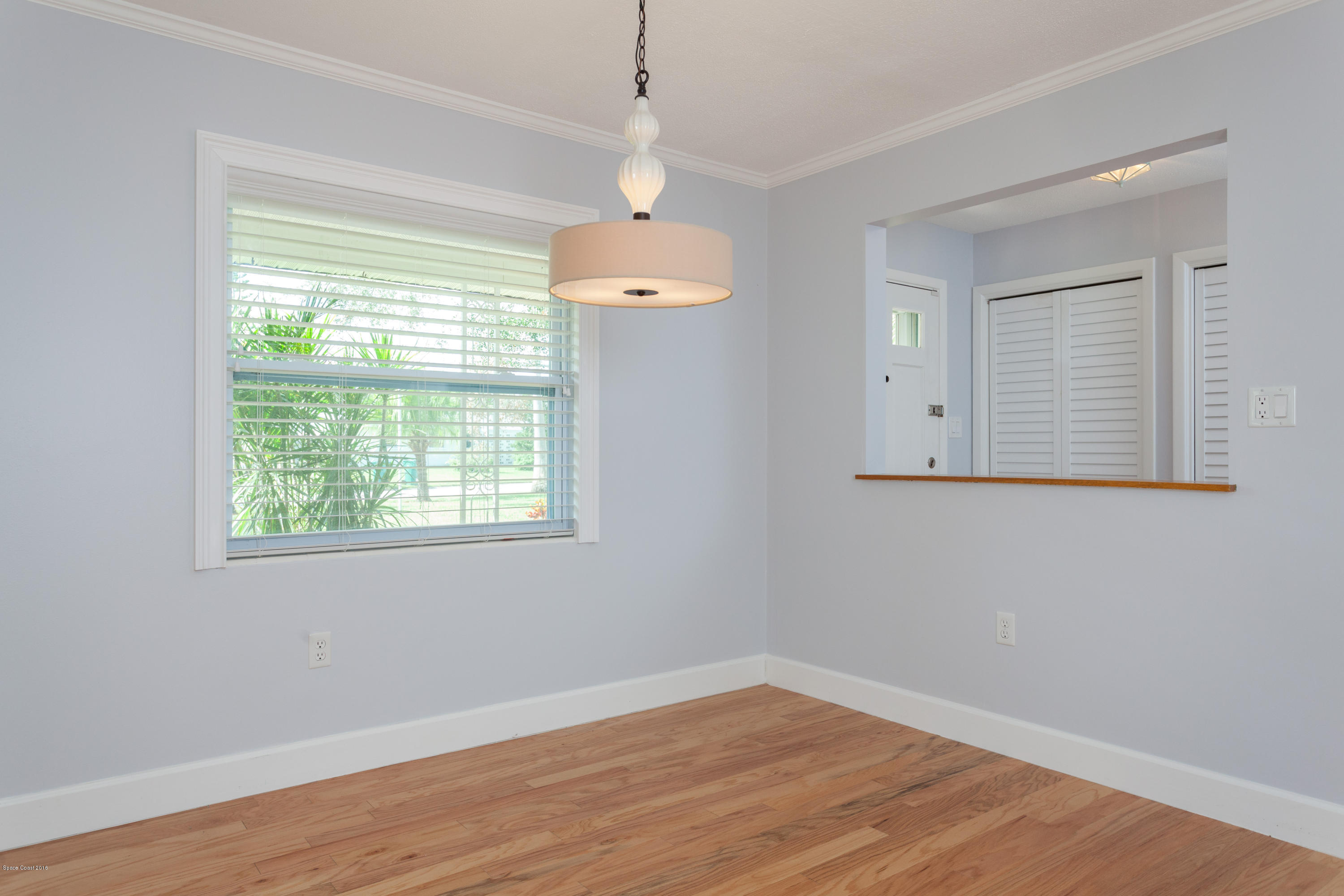 731 Java Road Cocoa Beach, FL 32931 - Photo 5 of 18 a view of an empty room with wooden floor and a window