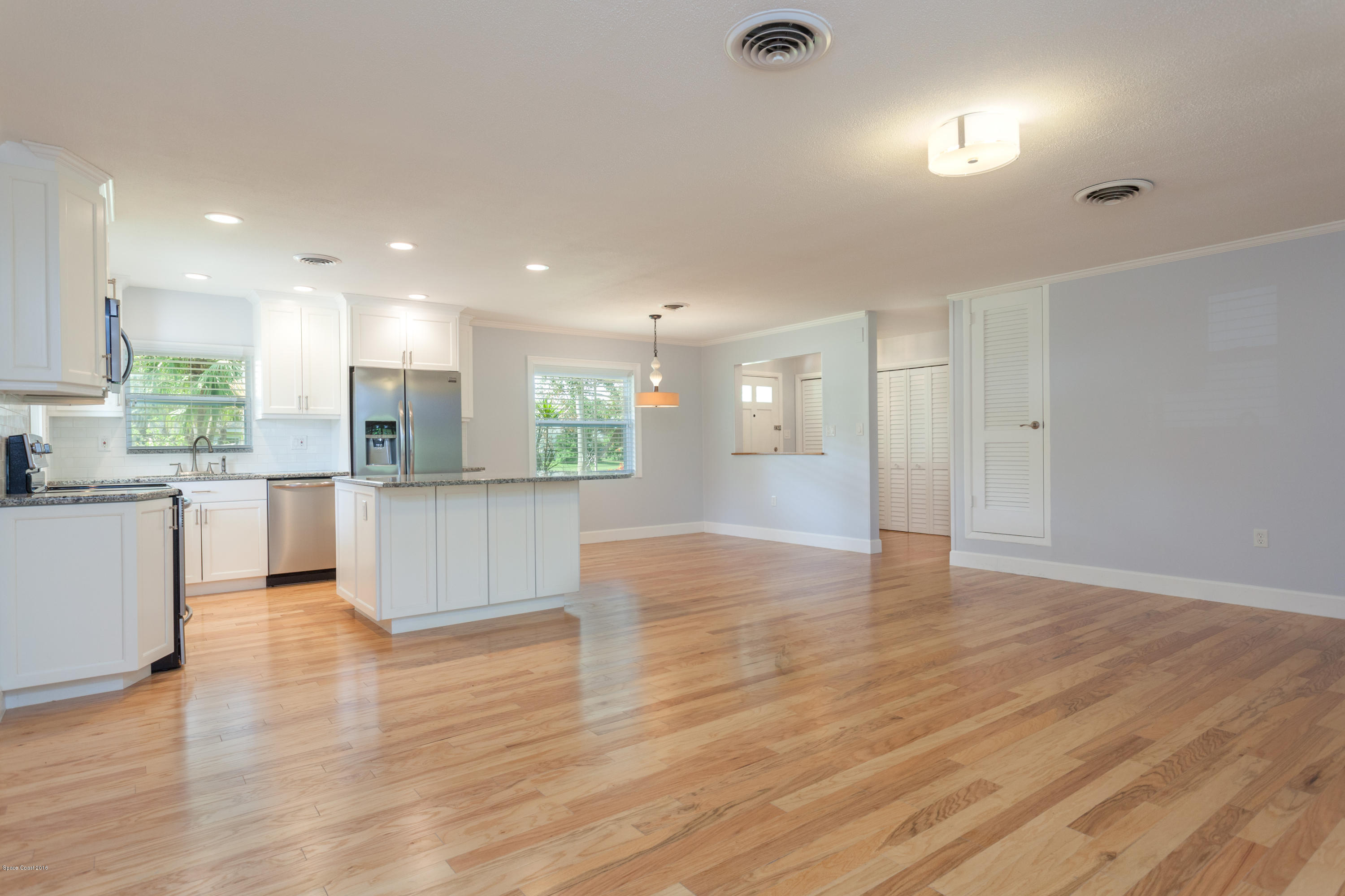 731 Java Road Cocoa Beach, FL 32931 - Photo 7 of 18 a view of kitchen with wooden floor and window