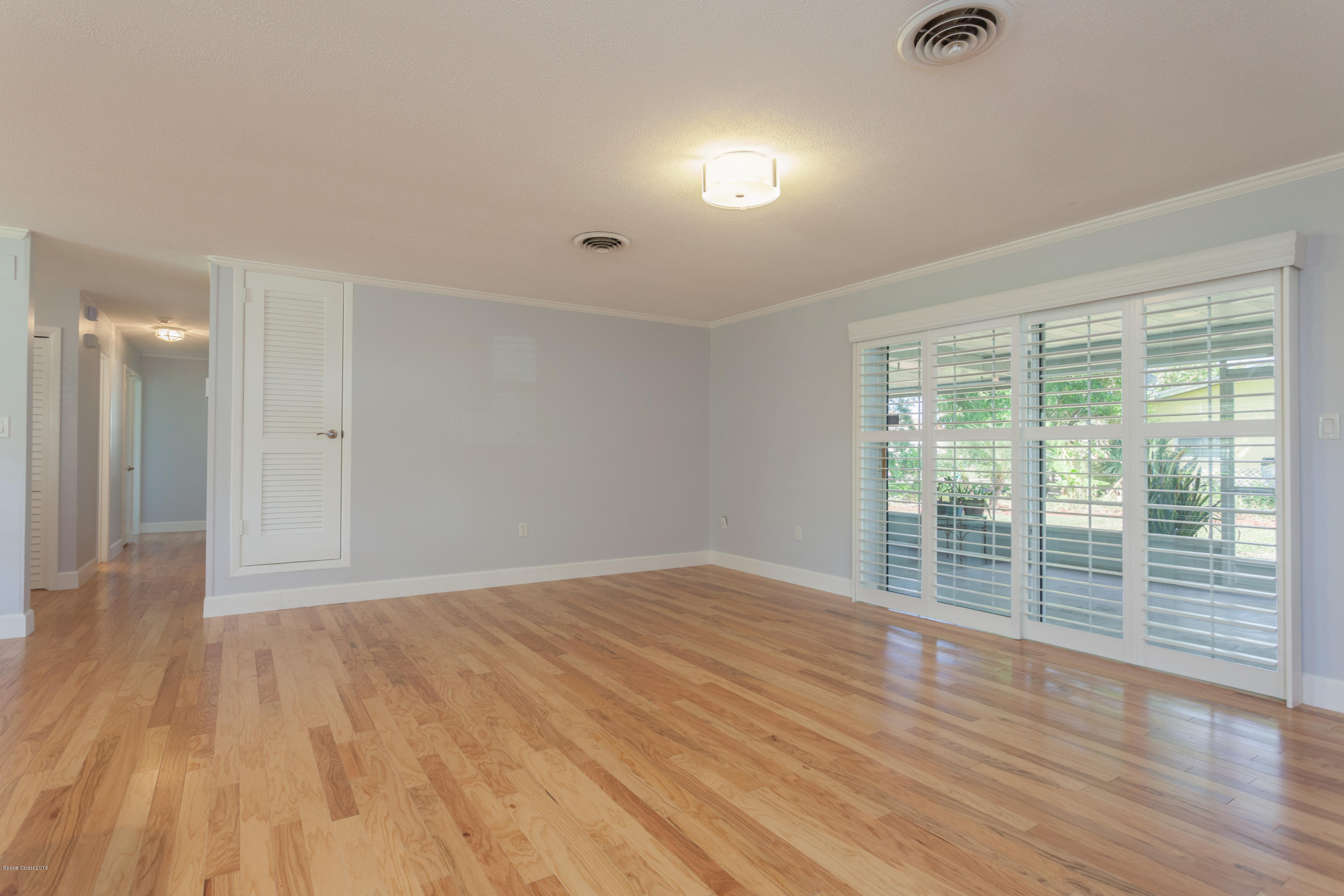 731 Java Road Cocoa Beach, FL 32931 - Photo 8 of 18 wooden floor in an empty room with a window