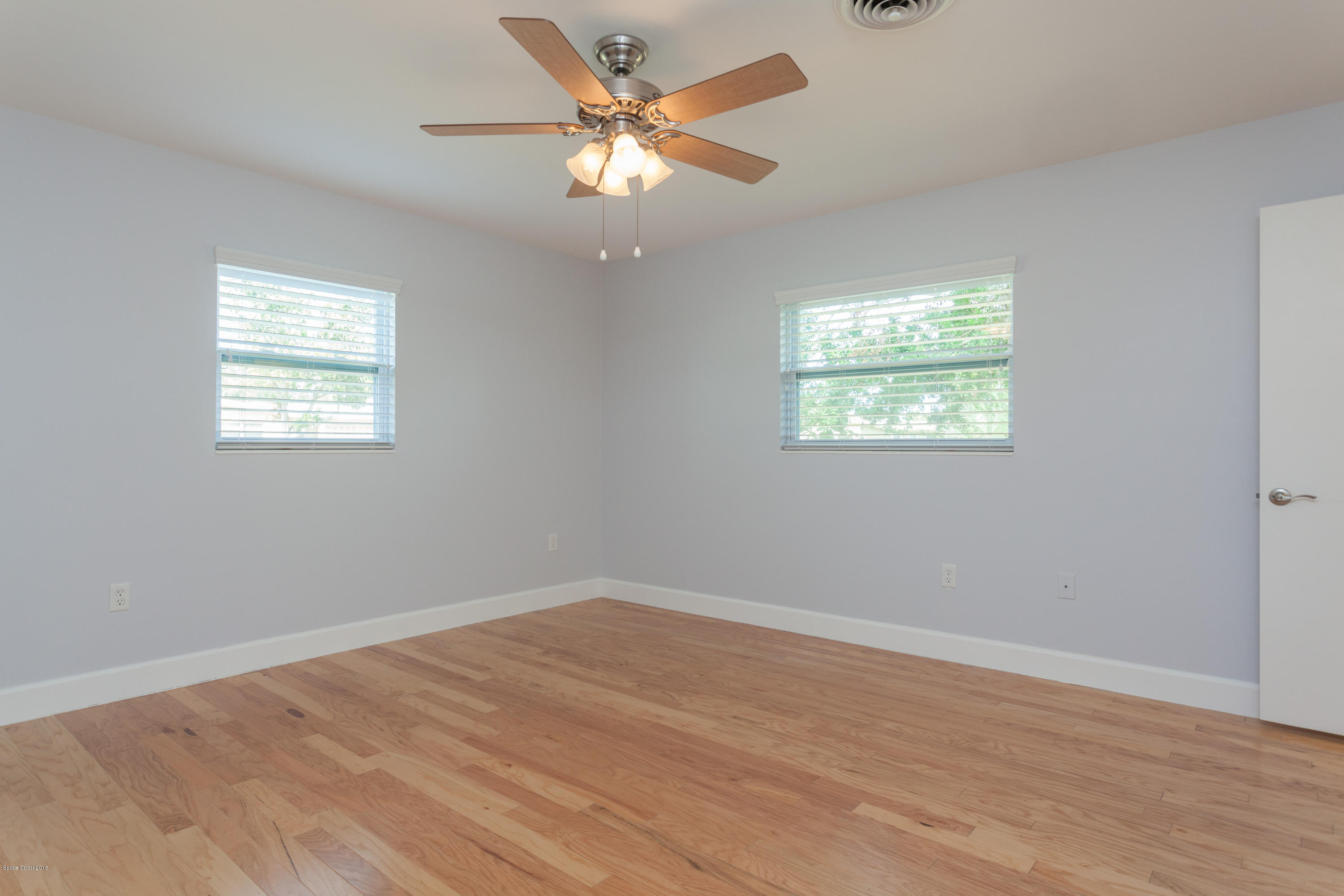 731 Java Road Cocoa Beach, FL 32931 - Photo 9 of 18 wooden floor in an empty room with a window