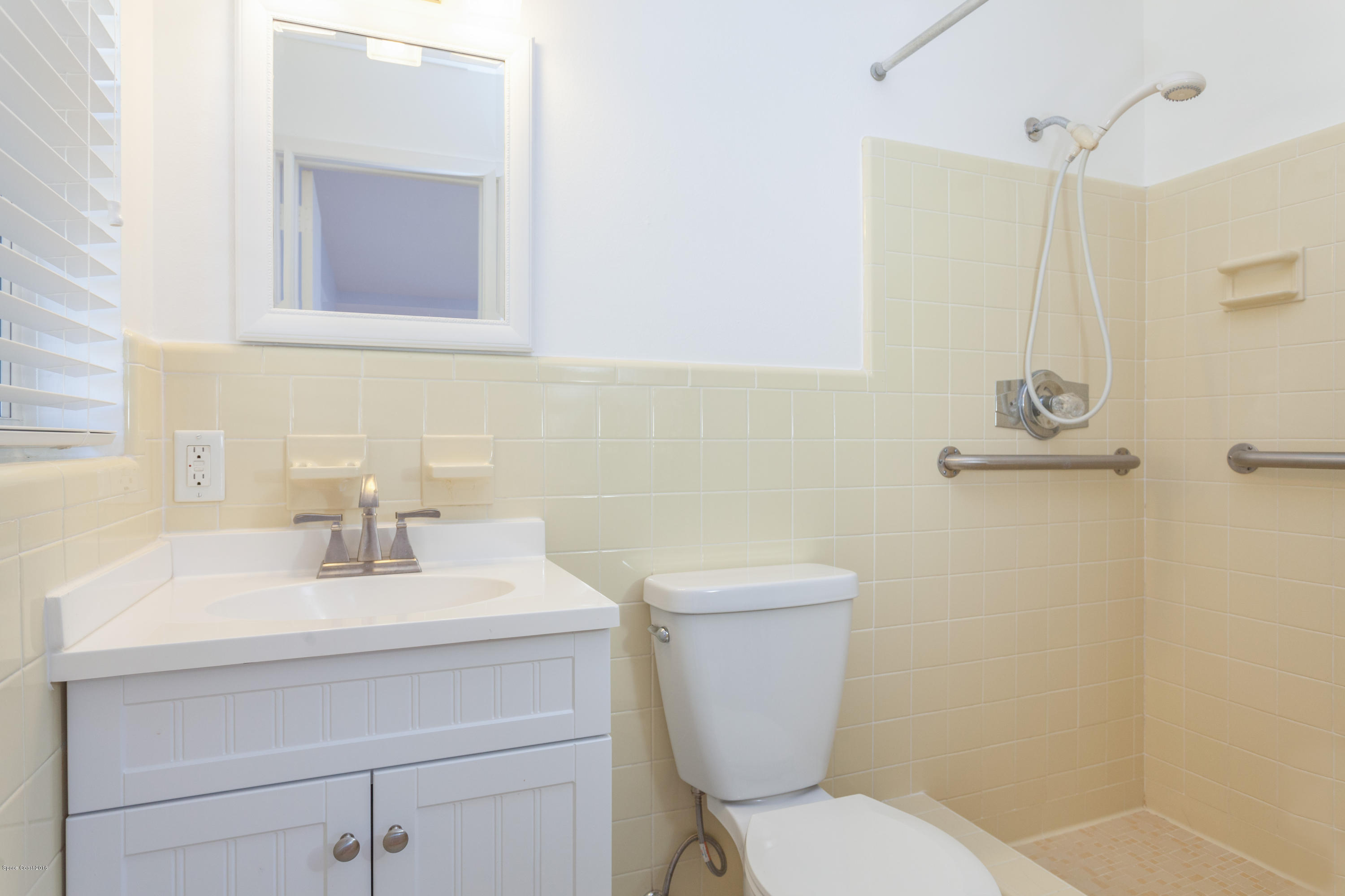 731 Java Road Cocoa Beach, FL 32931 - Photo 10 of 18 a bathroom with a sink mirror and toilet