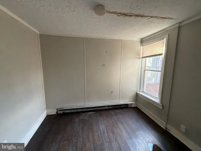 a view of a room with wooden floor and window